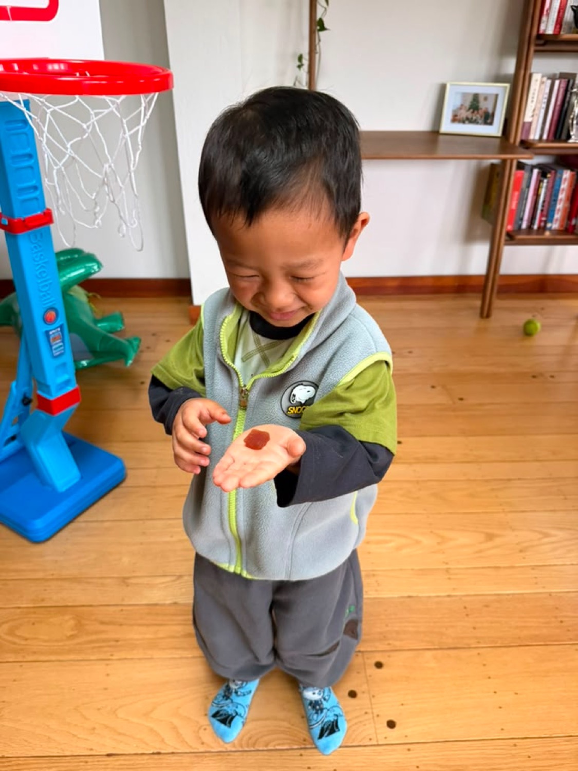 My son looking at a Melons gummy in his hand