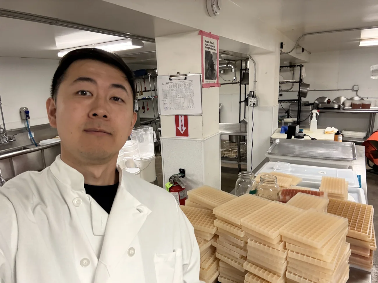 Me in a commercial kitchen with trays of gummies setting